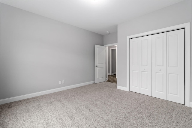 unfurnished bedroom featuring carpet floors and a closet