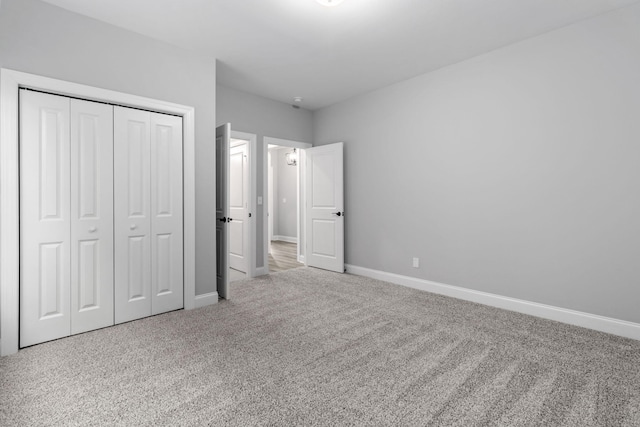 unfurnished bedroom with a closet and carpet floors