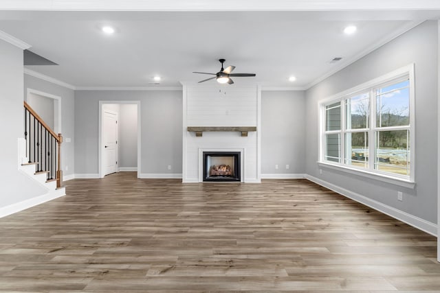 unfurnished living room with crown molding, light hardwood / wood-style floors, a fireplace, and ceiling fan