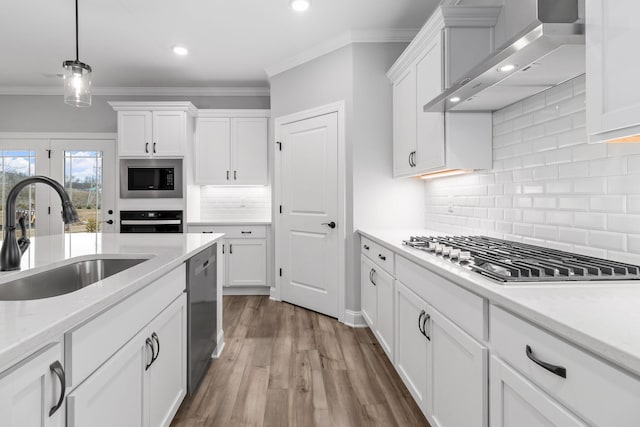 kitchen with sink, white cabinets, wall chimney exhaust hood, and black appliances