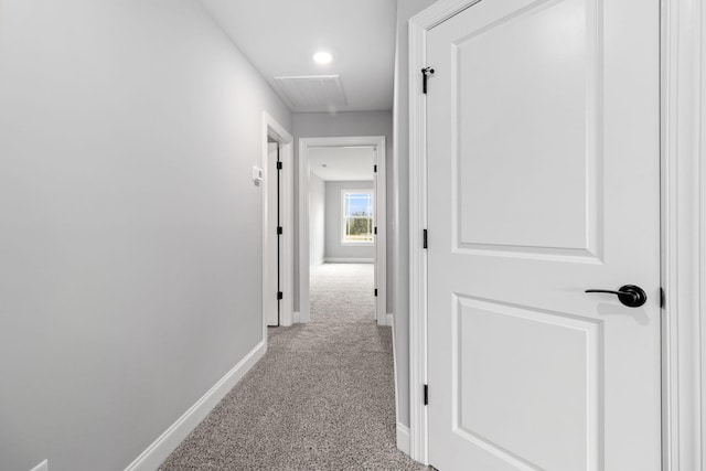 hall with light colored carpet