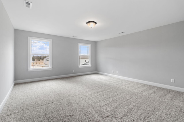 unfurnished room with carpet flooring and plenty of natural light