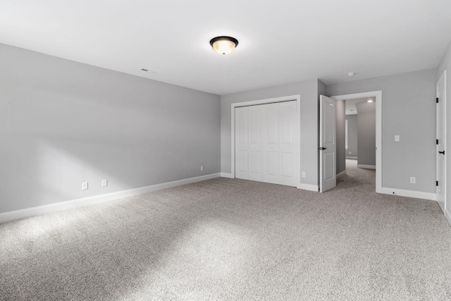 unfurnished bedroom with carpet and a closet