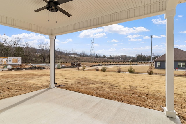 view of patio featuring ceiling fan and a rural view