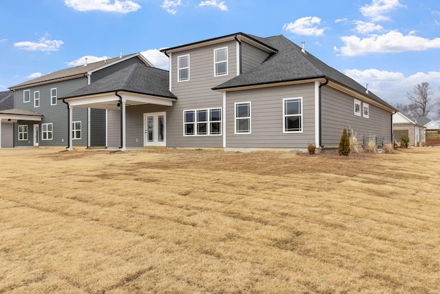 rear view of house featuring a yard and french doors