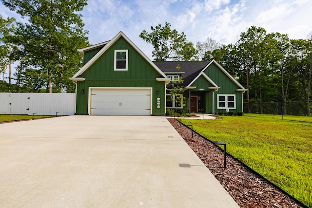 view of front of property featuring board and batten siding, driveway, a front yard, and fence