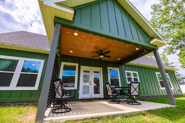 rear view of property with a ceiling fan, french doors, roof with shingles, board and batten siding, and a patio area