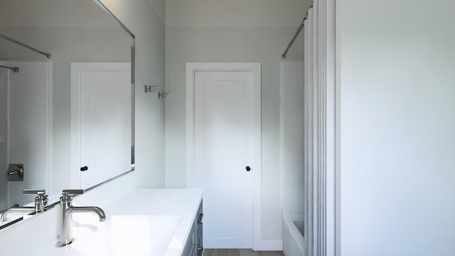 bathroom with washtub / shower combination and vanity