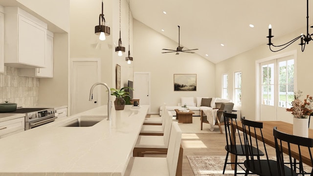 kitchen with sink, white cabinets, pendant lighting, and stainless steel electric range oven