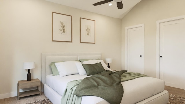 bedroom featuring ceiling fan, lofted ceiling, and hardwood / wood-style flooring