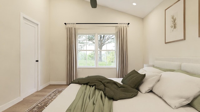 bedroom with ceiling fan, vaulted ceiling, and wood-type flooring