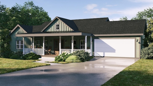 view of front of property with a porch, a front yard, and a garage