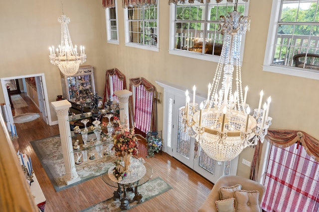 dining space with wood-type flooring and an inviting chandelier