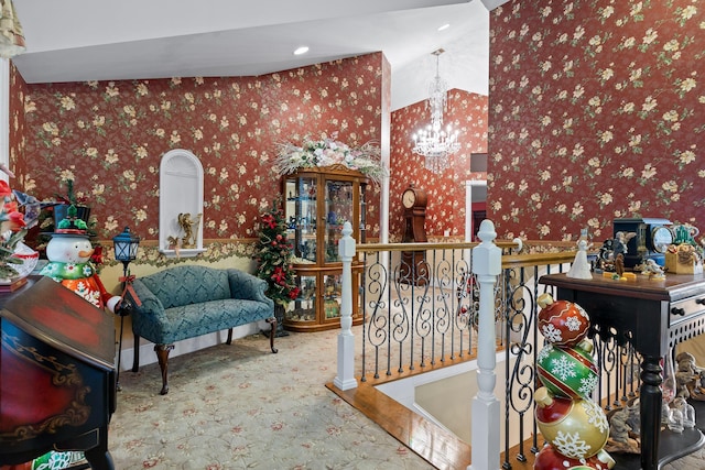 interior space with an upstairs landing, wallpapered walls, and an inviting chandelier