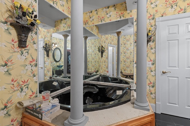 bathroom with decorative columns, wallpapered walls, and tile patterned floors