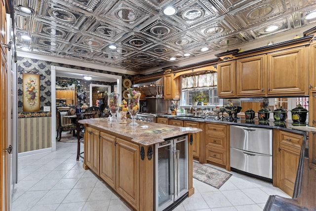 kitchen featuring wallpapered walls, a center island, an ornate ceiling, and beverage cooler