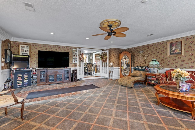 living area with a textured ceiling, wallpapered walls, and crown molding