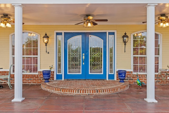 entrance to property with french doors, ceiling fan, and covered porch