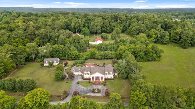 birds eye view of property with a view of trees