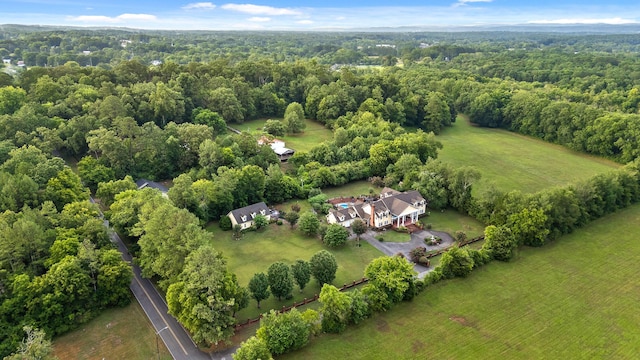 birds eye view of property featuring a view of trees