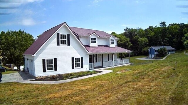 back of property featuring a lawn and covered porch