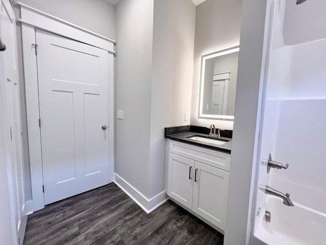 bathroom featuring vanity, hardwood / wood-style floors, and shower / bathing tub combination