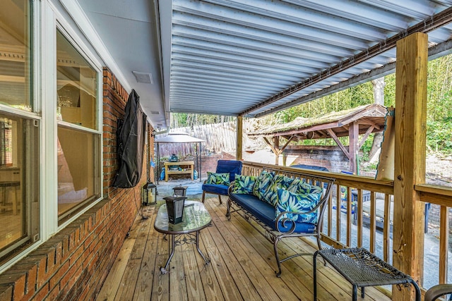 deck with a hot tub and outdoor lounge area