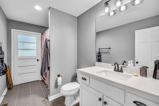 bathroom featuring vanity and toilet