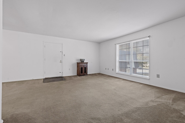 unfurnished living room featuring carpet flooring