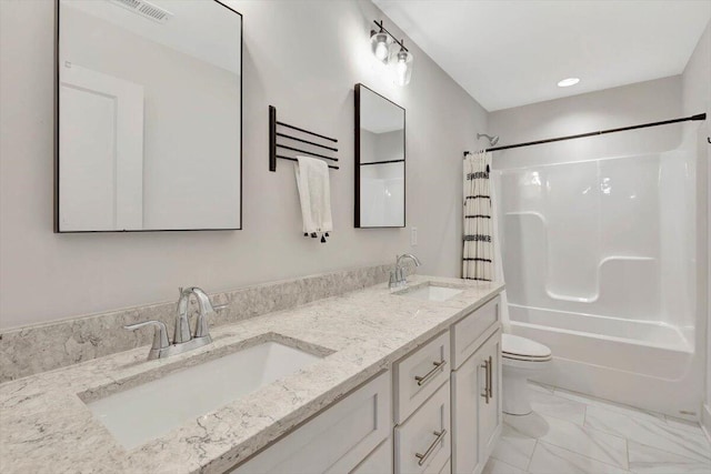 full bathroom featuring shower / bath combo with shower curtain, toilet, and vanity