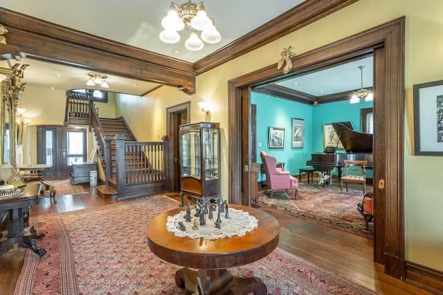 interior space with ornamental molding, a notable chandelier, and wood-type flooring