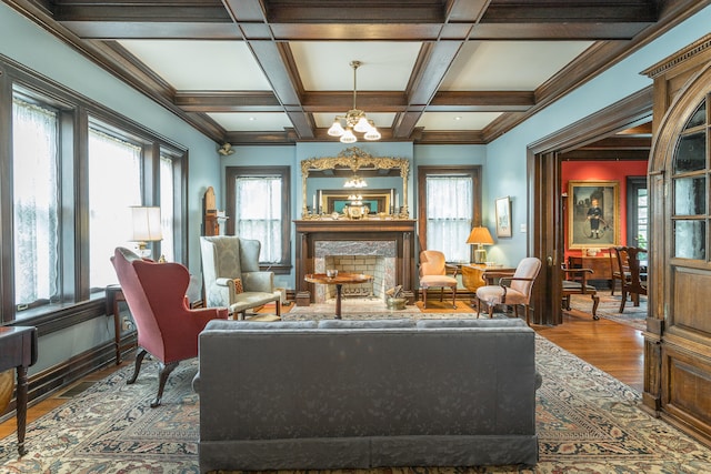 living room featuring coffered ceiling, a chandelier, dark hardwood / wood-style flooring, and beamed ceiling