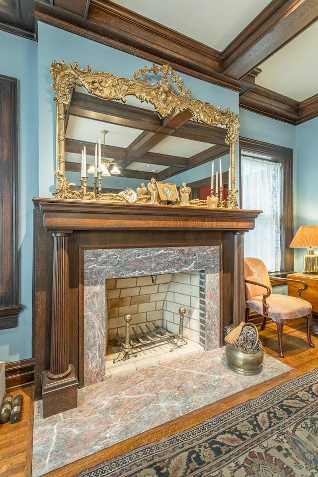 room details with coffered ceiling, a fireplace, beam ceiling, and crown molding