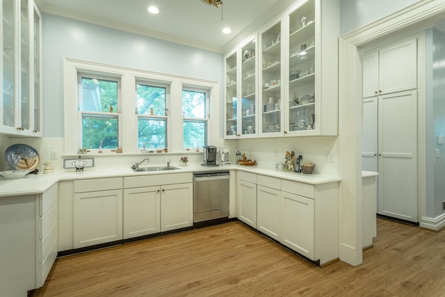 kitchen featuring light hardwood / wood-style flooring, stainless steel dishwasher, ornamental molding, sink, and white cabinets