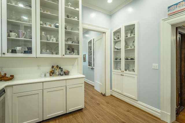 bar with dishwasher, ornamental molding, and hardwood / wood-style floors