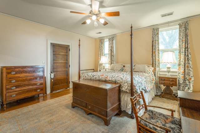 bedroom with ceiling fan and hardwood / wood-style flooring