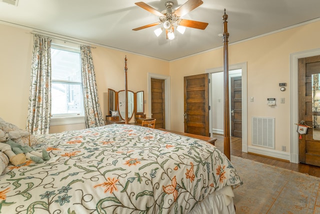 bedroom with ceiling fan, crown molding, and wood-type flooring