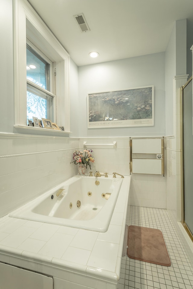 bathroom featuring tile walls, separate shower and tub, and tile patterned flooring