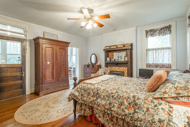 bedroom with ceiling fan, wood-type flooring, and ornamental molding