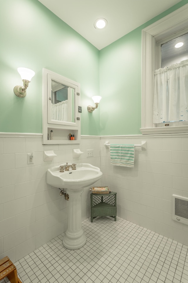 bathroom featuring tile patterned flooring, tile walls, and backsplash