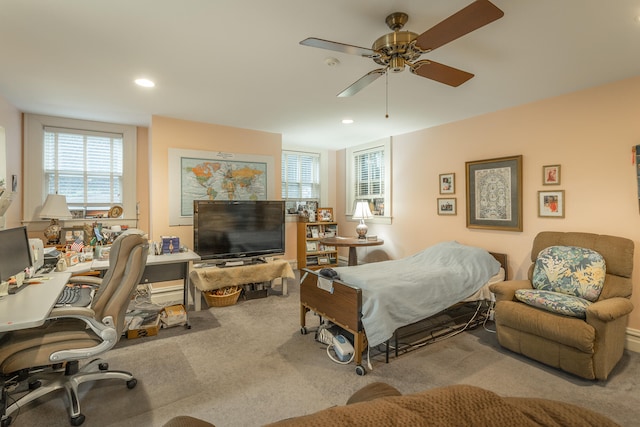 bedroom featuring ceiling fan and light carpet