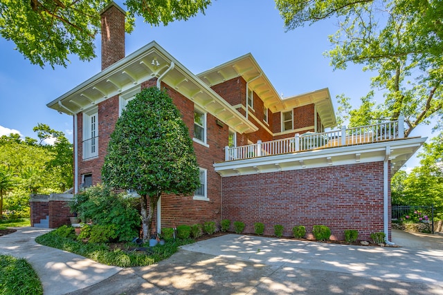 view of side of home with a balcony