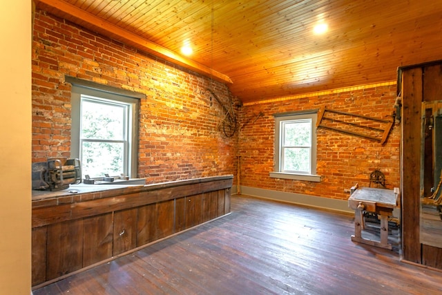 interior space with wood ceiling, brick wall, and dark hardwood / wood-style flooring