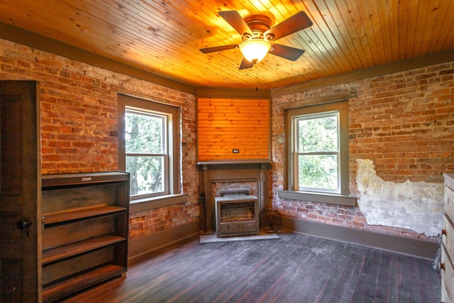 unfurnished living room with brick wall, dark hardwood / wood-style floors, a fireplace, wood ceiling, and ceiling fan