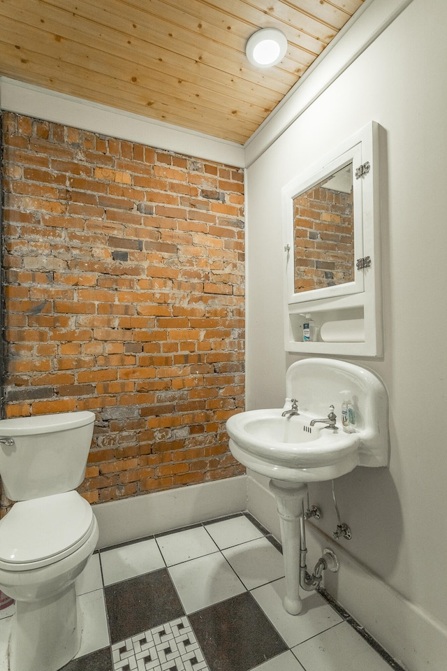 bathroom featuring wooden ceiling, crown molding, toilet, and tile patterned floors