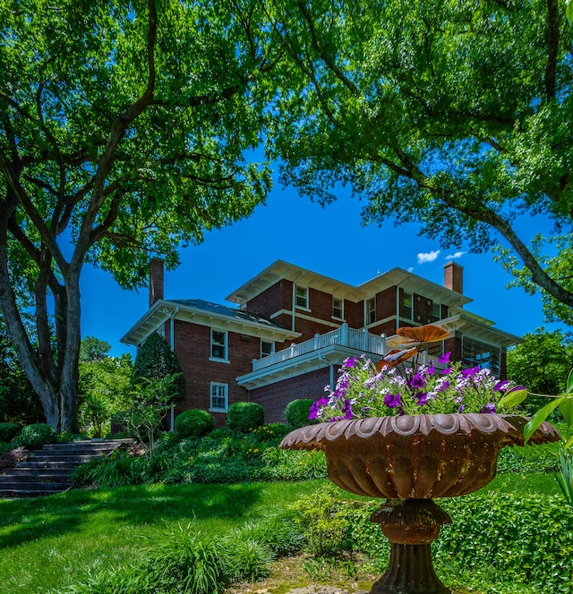 rear view of house featuring a lawn