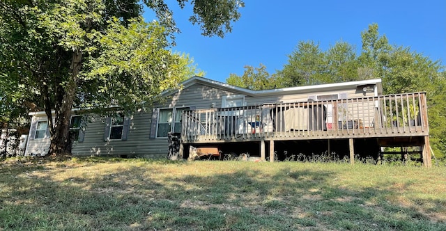 rear view of house featuring a yard and a deck