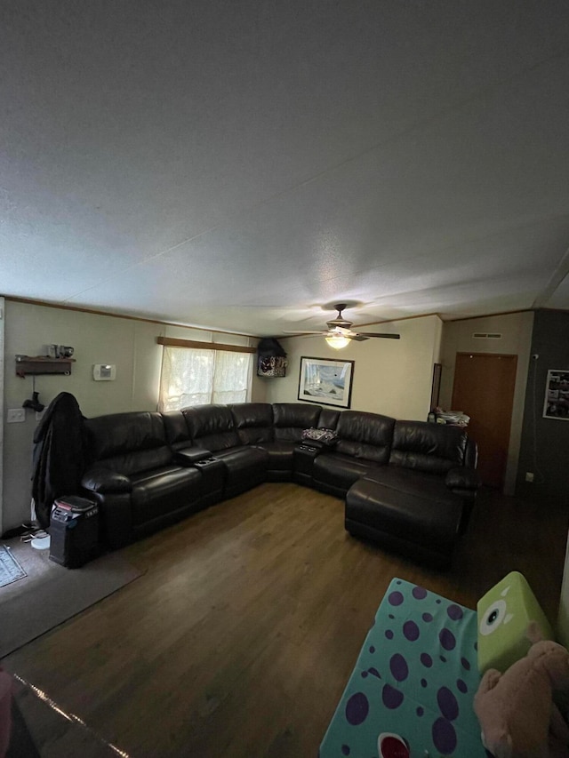 living room with wood-type flooring, a textured ceiling, and ceiling fan