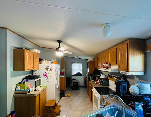 kitchen featuring ceiling fan, white appliances, and vaulted ceiling