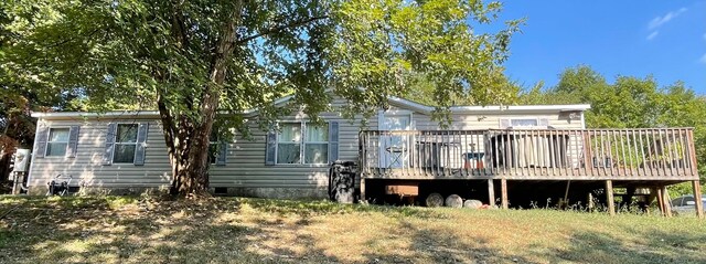 back of property featuring a wooden deck